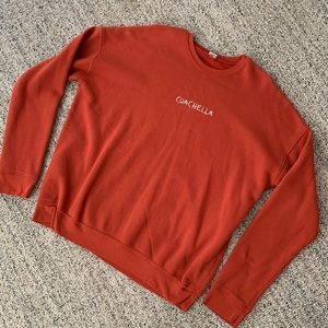 Coachella rust colored sweatshirt.